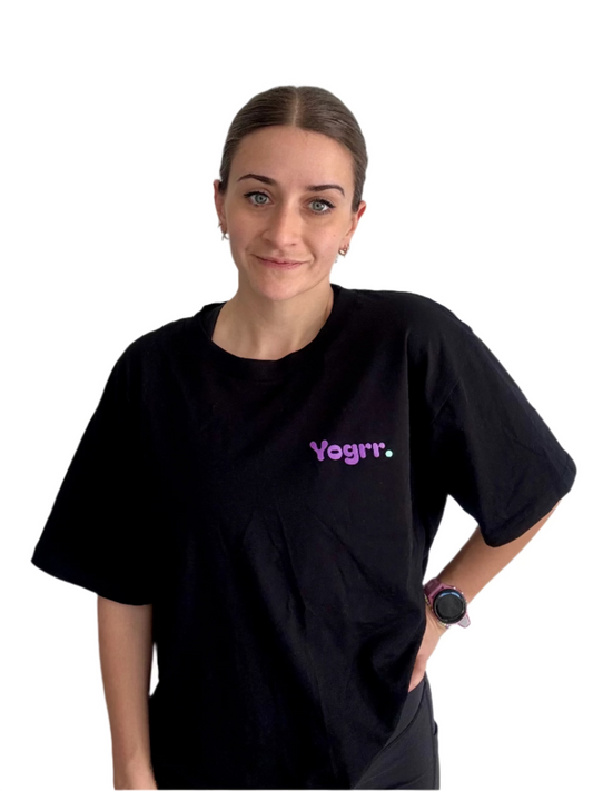 Person wearing a black t-shirt with 'Yogrr' logo against a plain background