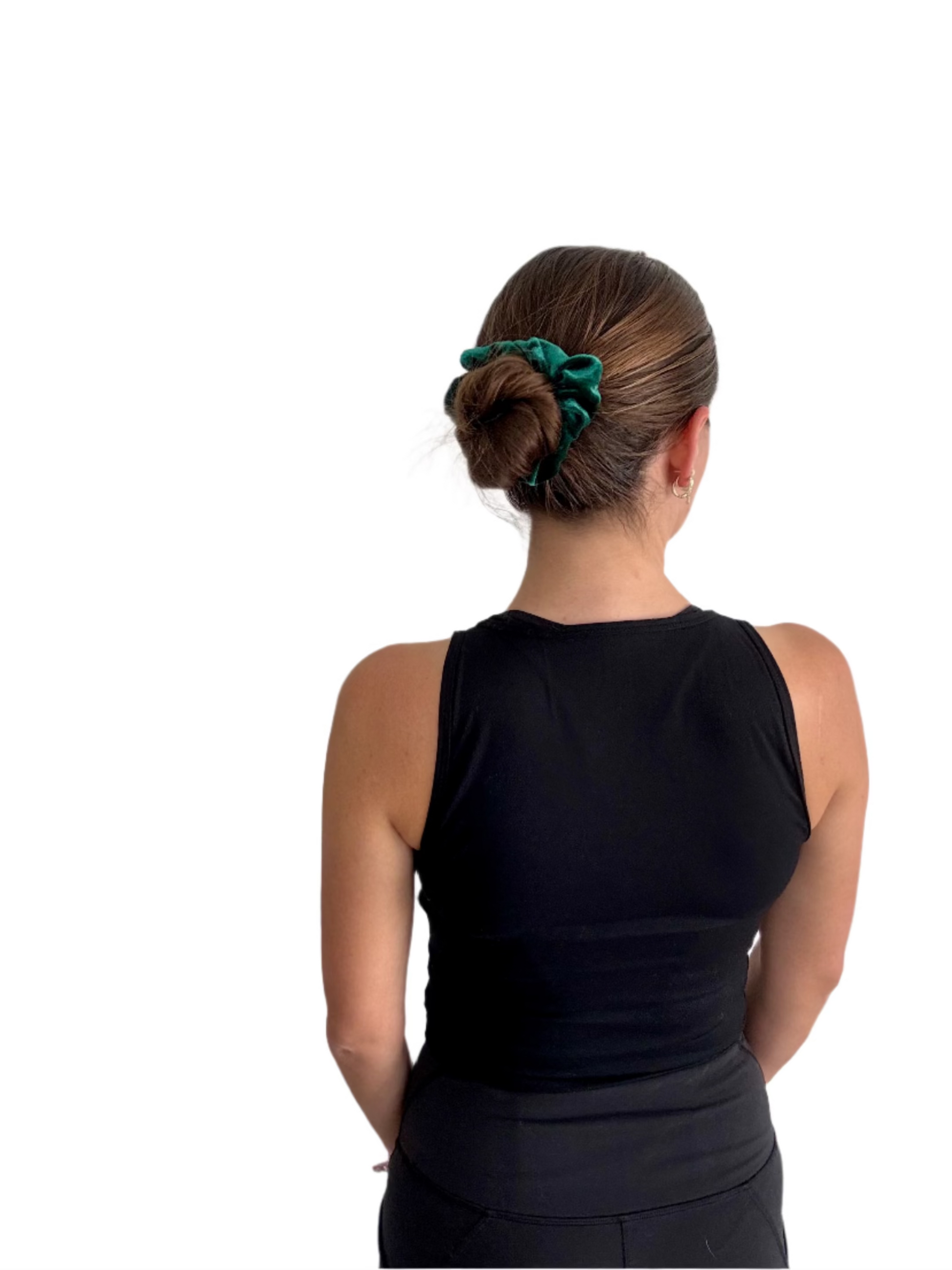 Person wearing a black sleeveless top with a green scrunchie in their hair against a plain background